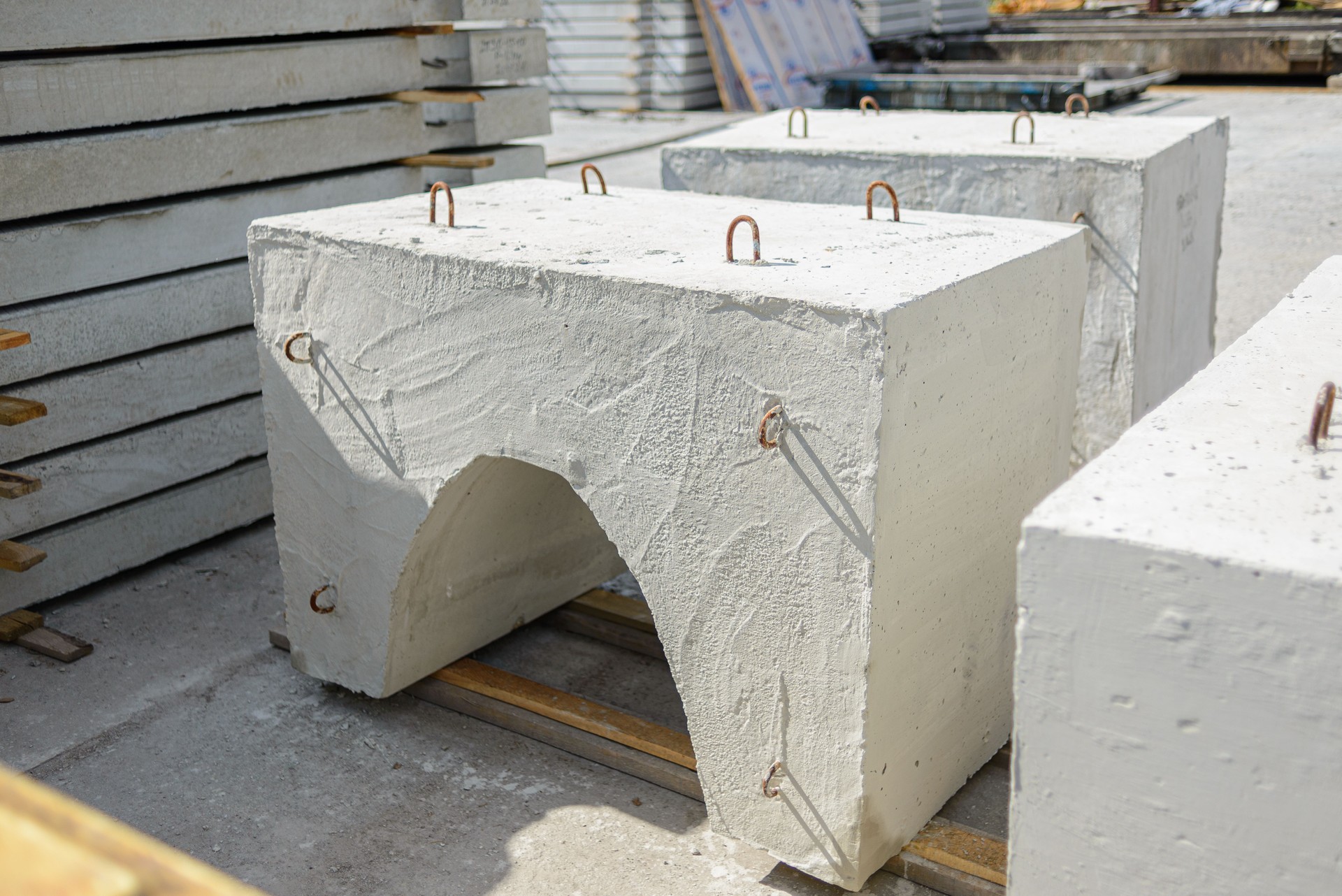 Reinforced concrete weighting agent of wedge-shaped type ubkm ready for shipment at the warehouse of a precast concrete plant.